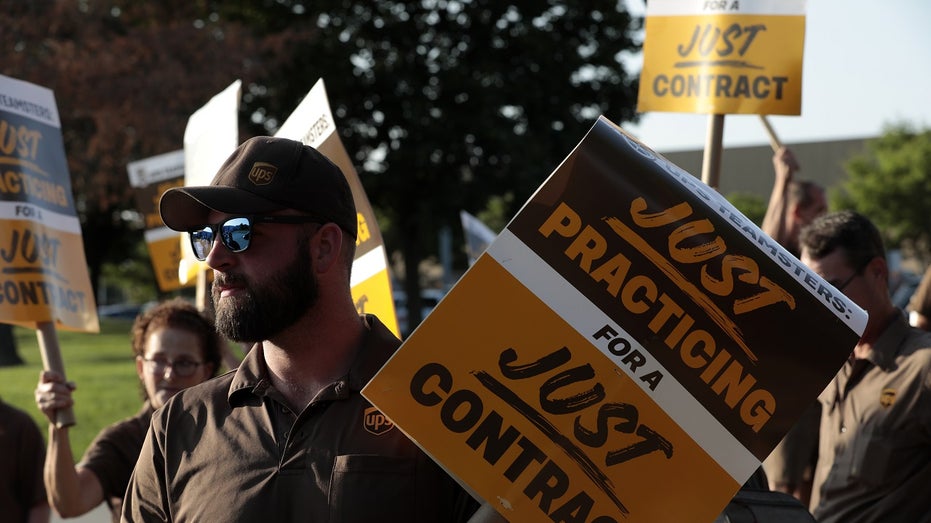 UPS worker holds sign during protest