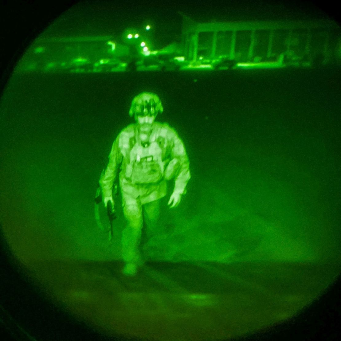 US Army Maj. Gen. Chris Donahue, commander of the 82nd Airborne Division, steps on board a transport plane as what the XVIII Airborne Corps calls the last soldier to leave Kabul, Afghanistan, August 30, 2021, in a photograph using night vision optics.